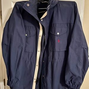 Polo jacket with hood in collar. Zipper and Snap front vented back.